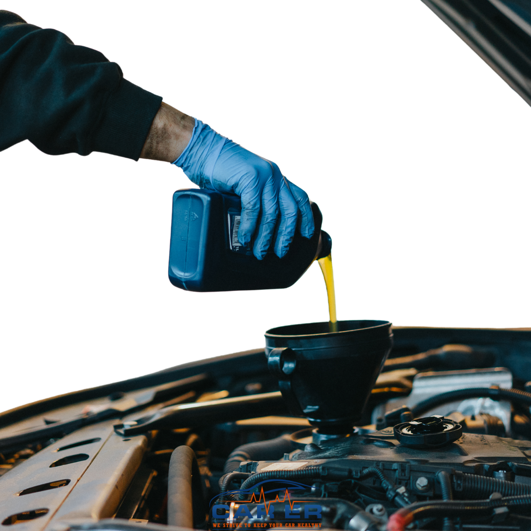 A mechanic wearing blue gloves pouring fresh engine oil into a car using a funnel during an oil change at Car ER in Harrisonburg, VA.
